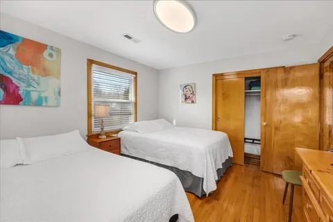 a bedroom with beds and a window