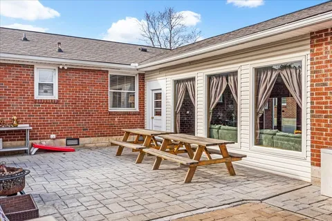 a building outdoor space with patio furniture and potted plants