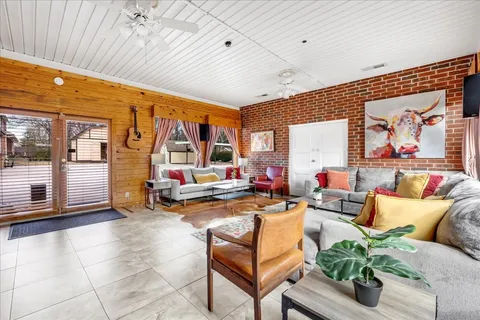 a living room with furniture a rug and a chandelier