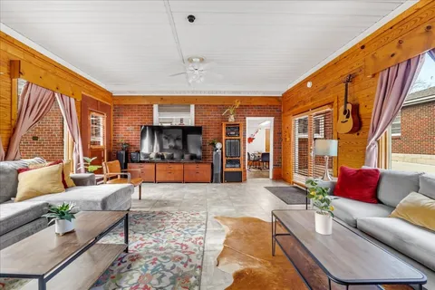 a living room with furniture and large windows