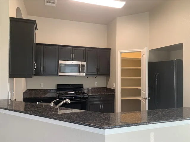 an empty room with a window and wooden floor