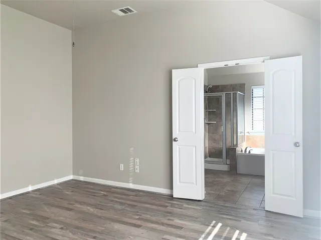a bathroom with a granite countertop sink and a bathtub next to a window