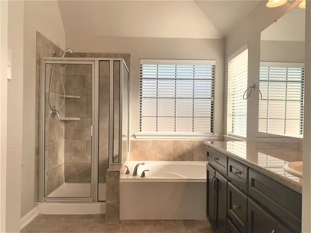 a front view of a house with a garden and yard