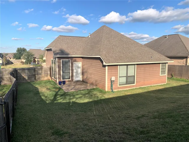 a front view of a house with a yard garage and outdoor seating