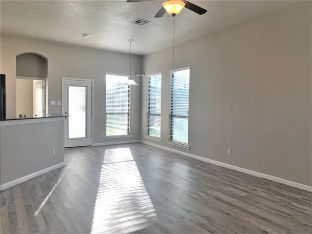 a kitchen with stainless steel appliances granite countertop a sink and a refrigerator
