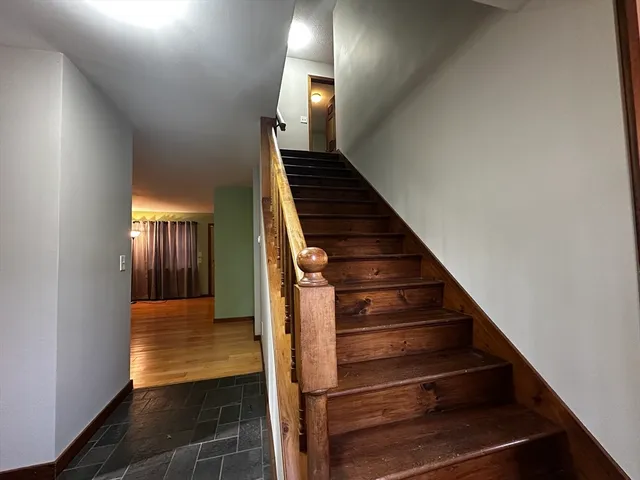 a view of entryway and hall with wooden floor