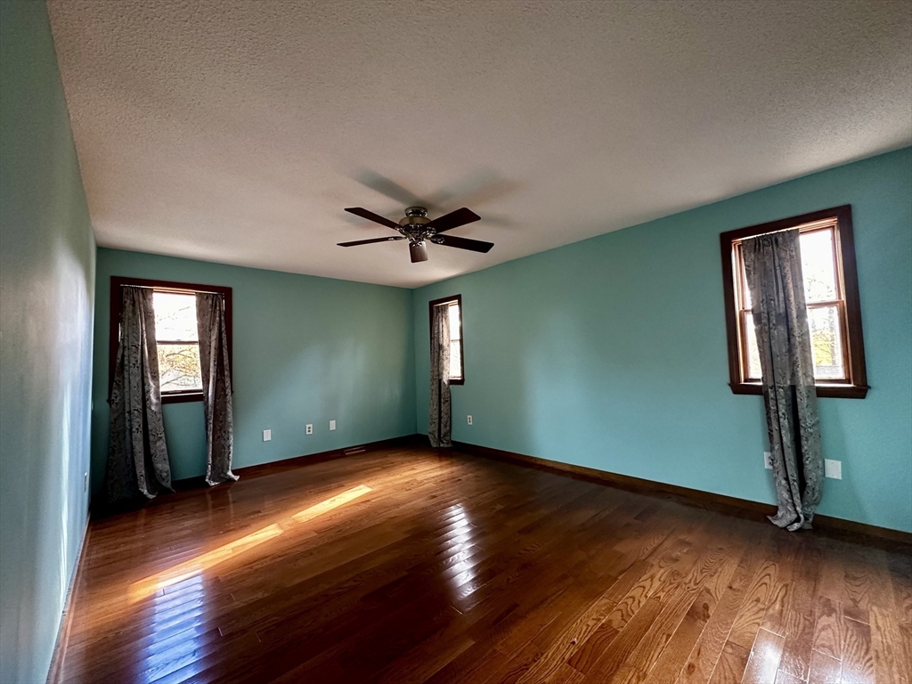 46 Swan Point Road Rindge, NH 03461 - Photo 18 of 42 a view of empty room with wooden floor and fan