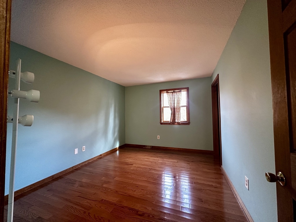 46 Swan Point Road Rindge, NH 03461 - Photo 22 of 42 a view of an empty room with wooden floor and a window