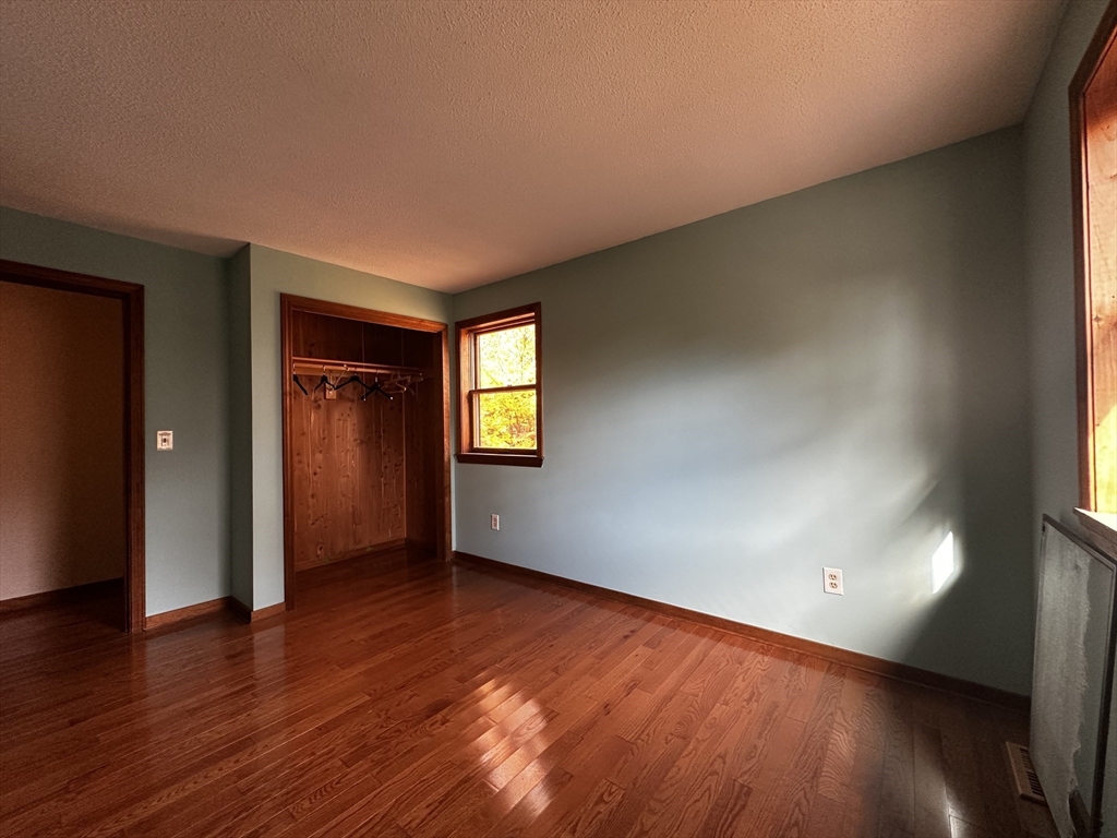 46 Swan Point Road Rindge, NH 03461 - Photo 25 of 42 an empty room with wooden floor and windows
