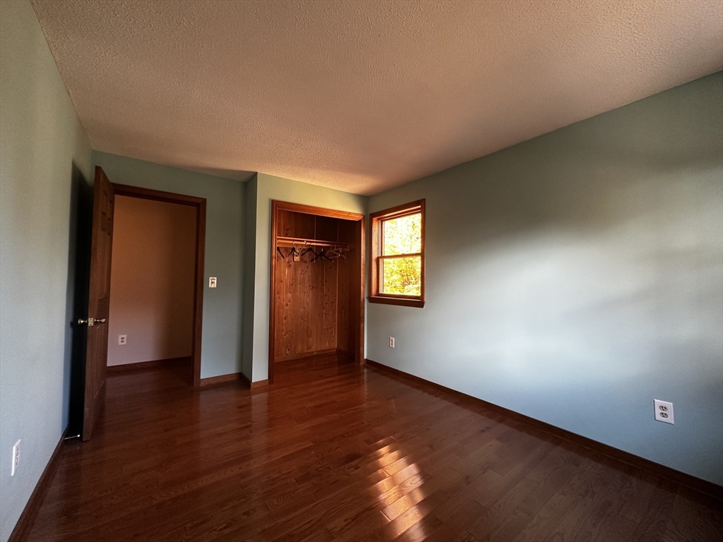 46 Swan Point Road Rindge, NH 03461 - Photo 27 of 42 an empty room with wooden floor and closet