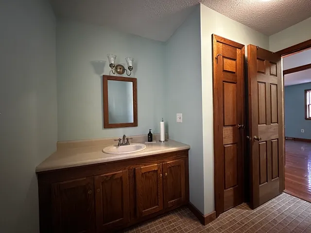a bathroom with a sink a mirror and shower