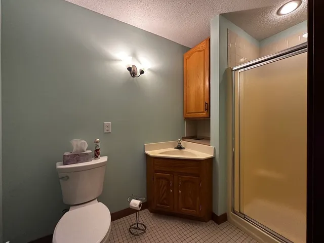 a bathroom with a sink toilet and mirror