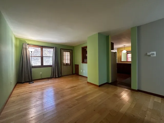 an empty room with closet and windows