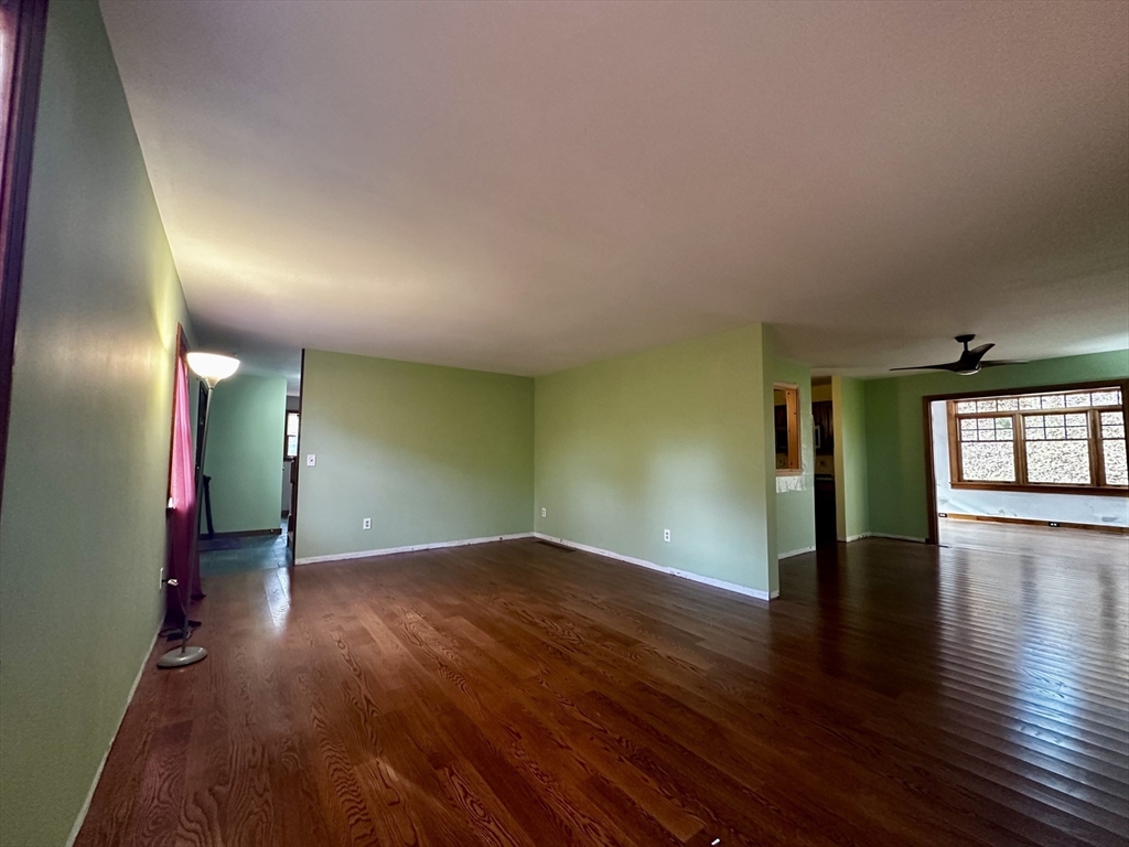 46 Swan Point Road Rindge, NH 03461 - Photo 8 of 42 an empty room with wooden floor and windows
