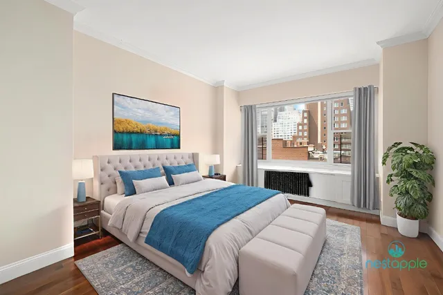 a bedroom with a large bed and a potted plant