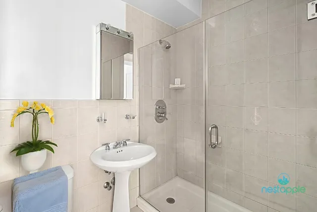 a bathroom with a sink mirror and shower