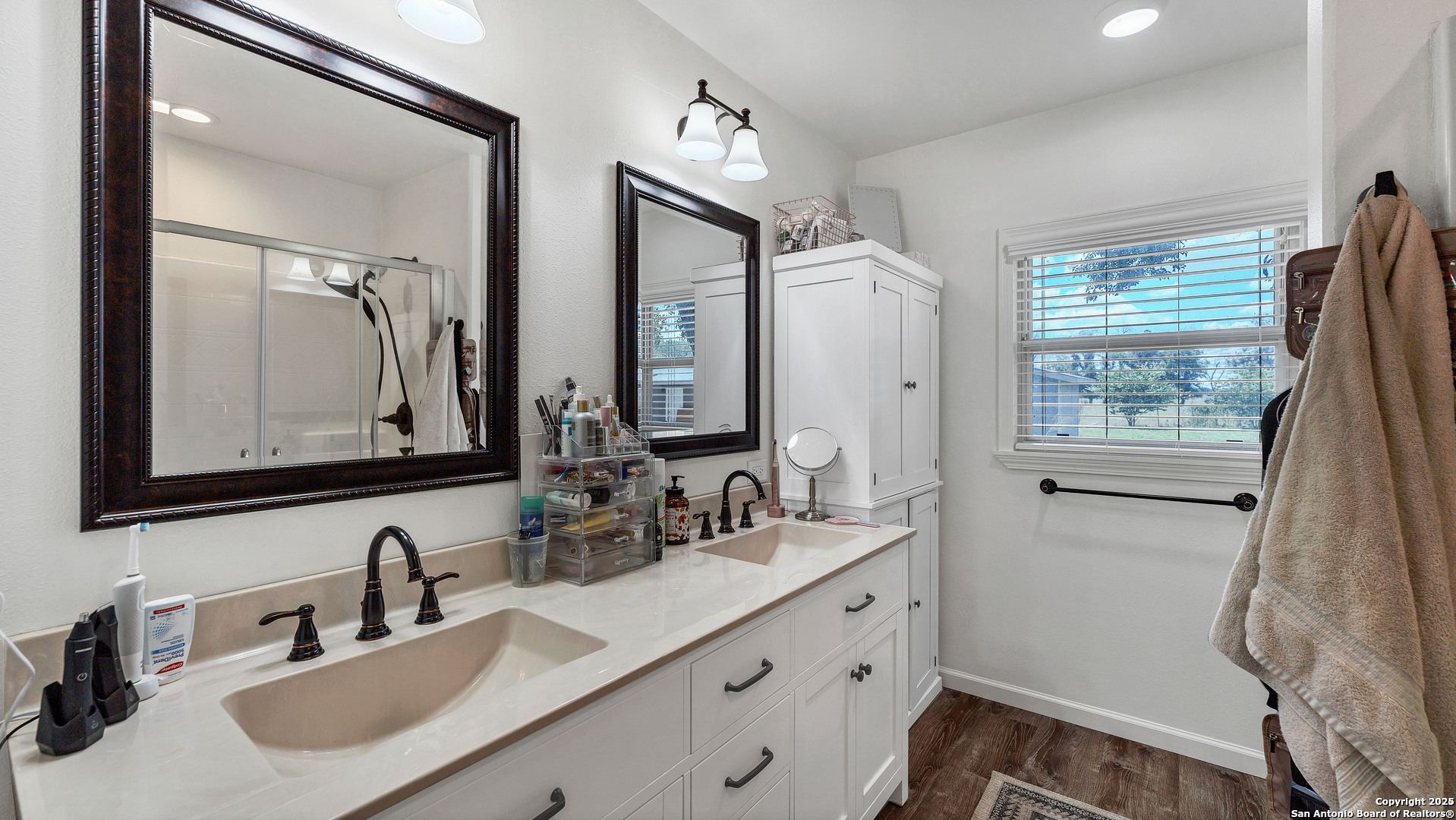 404 Reiley Road Seguin, TX 78155 - Photo 11 of 45 a bathroom with double vanity sink and a mirror