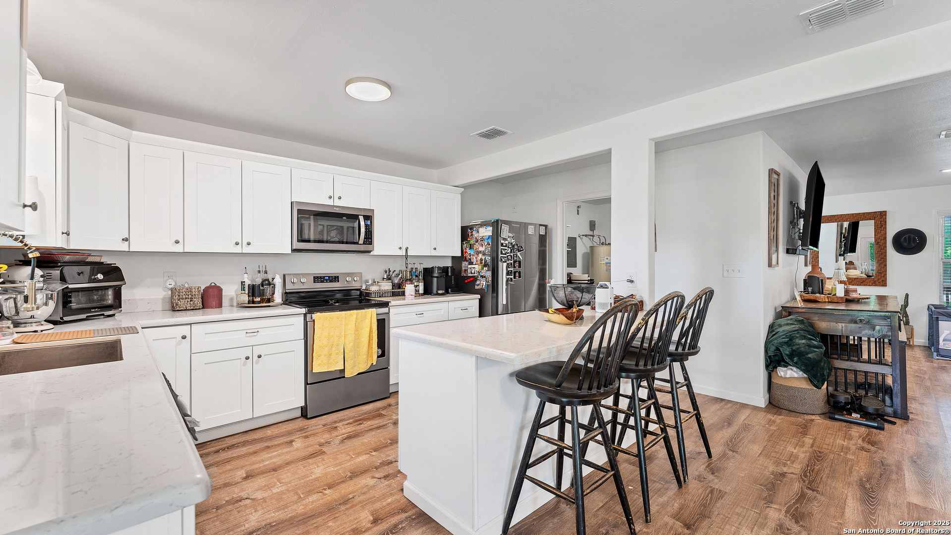 404 Reiley Road Seguin, TX 78155 - Photo 19 of 45 a kitchen with stainless steel appliances a dining table chairs stove refrigerator and cabinets