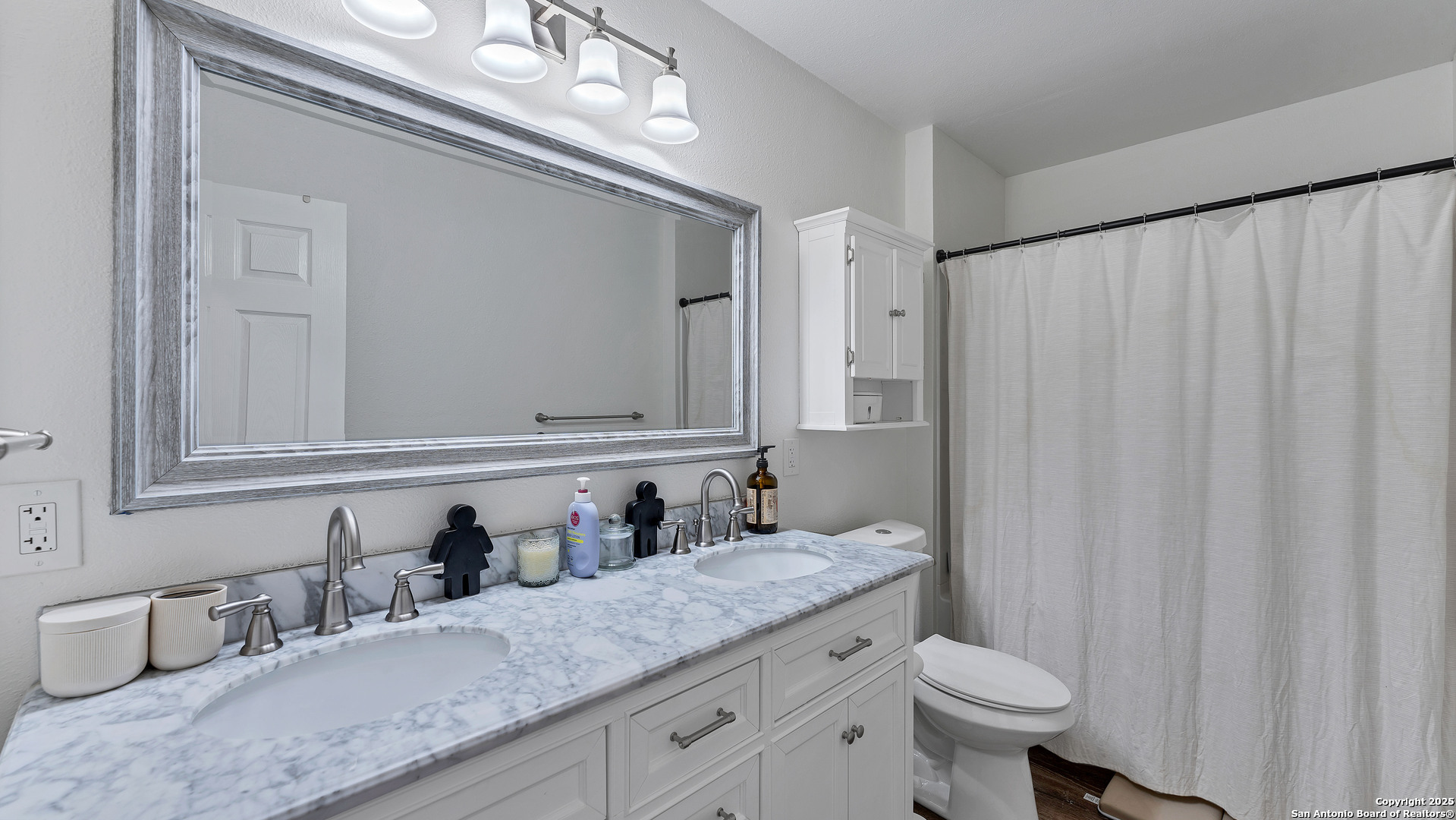 404 Reiley Road Seguin, TX 78155 - Photo 25 of 45 a bathroom with a granite countertop sink and a mirror
