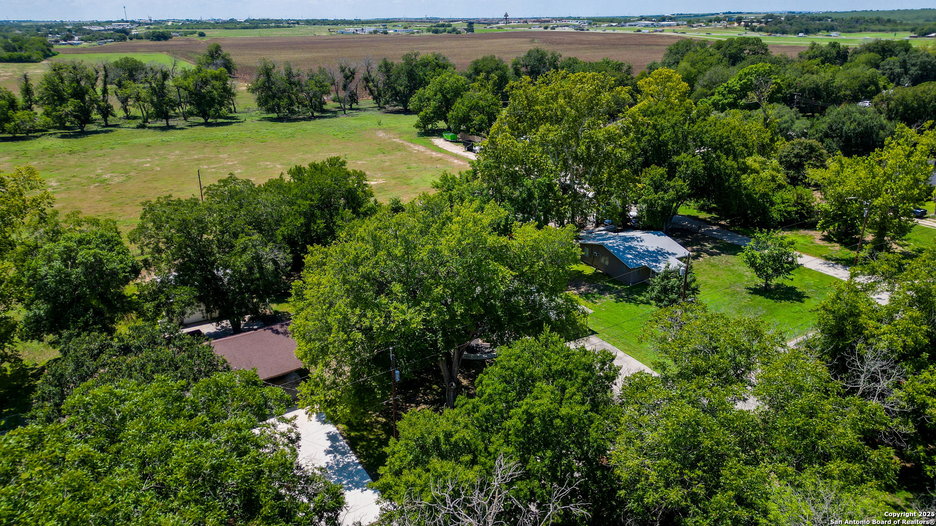 404 Reiley Road Seguin, TX 78155 - Photo 38 of 45 an aerial view of a yard with plants and large trees