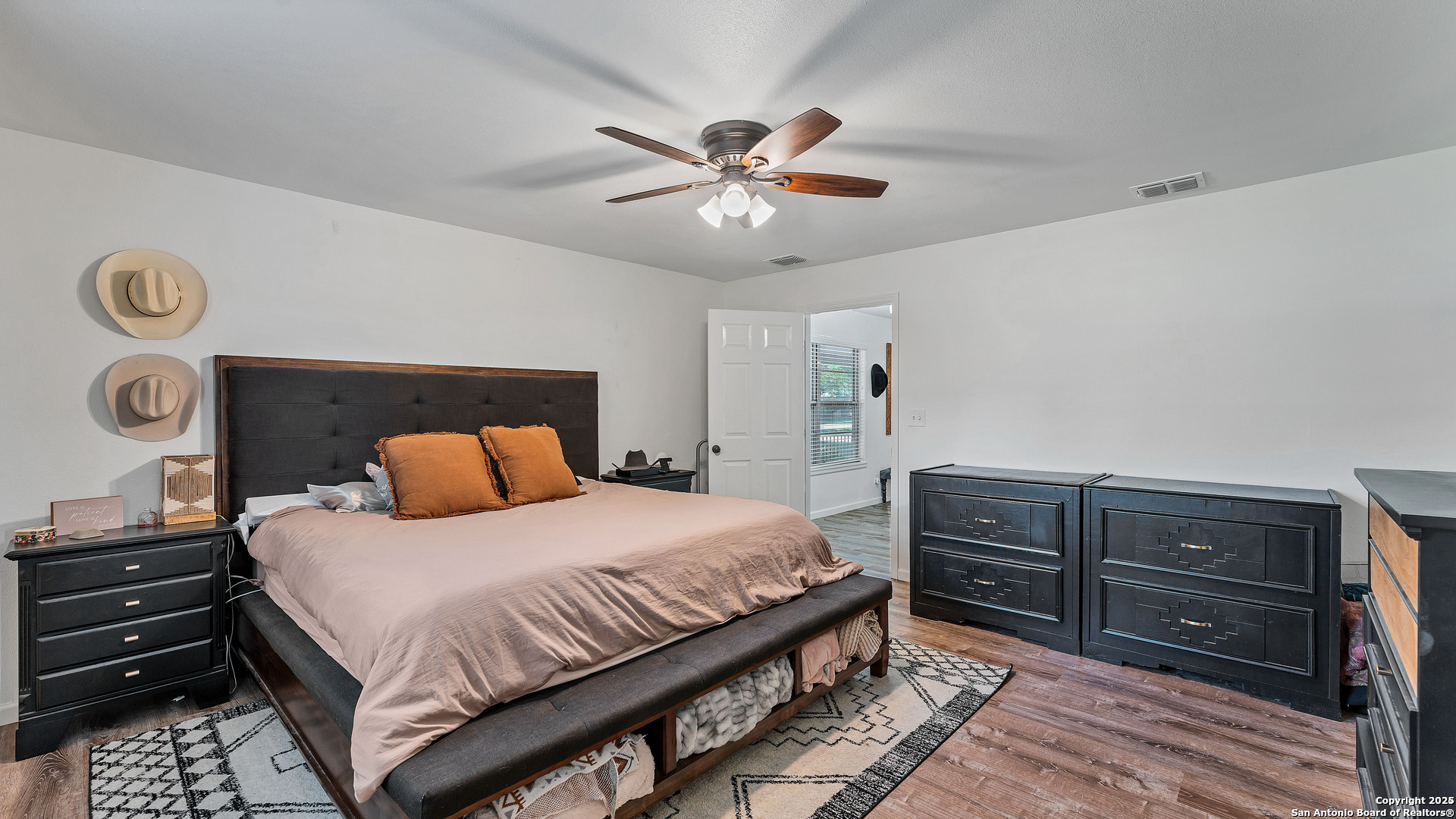 404 Reiley Road Seguin, TX 78155 - Photo 9 of 45 a bedroom with a bed and a chandelier