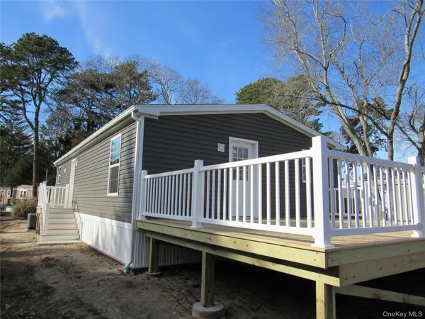 a view of backyard with a deck and furniture