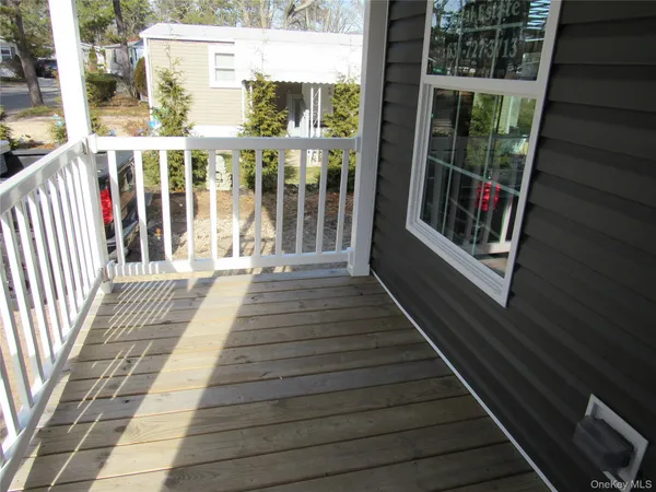 a view of a balcony with wooden floor