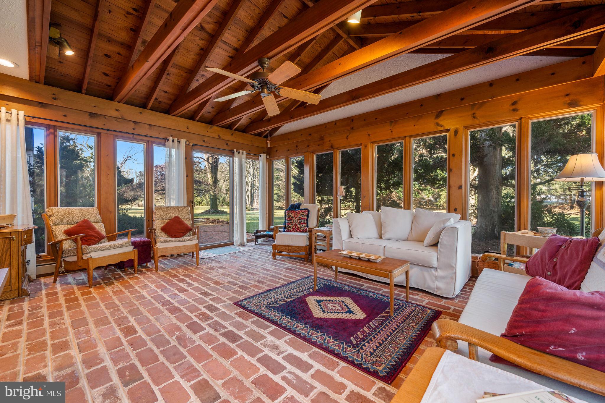 21 Flintshire Road Malvern, PA 19355 - Photo 18 of 40 Sunroom with brick floor & vaulted ceiling