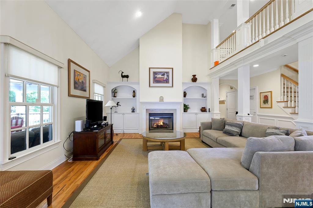 22 Meadowlake Drive Mahwah, NJ 07430 - Photo 18 of 39 a living room with furniture a large window and a fireplace