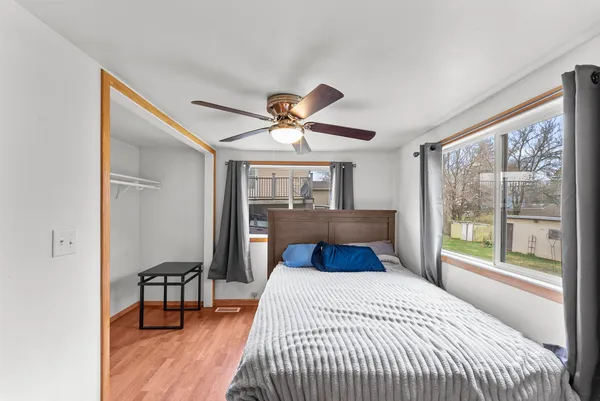a bedroom with a large bed and a large window