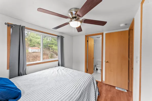 a bedroom with a bed and a window