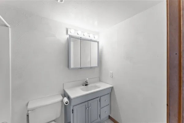 a bathroom with a sink toilet and mirror