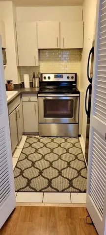 a kitchen with a stove and a microwave