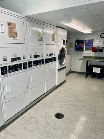 a wooden bench sitting in front of building