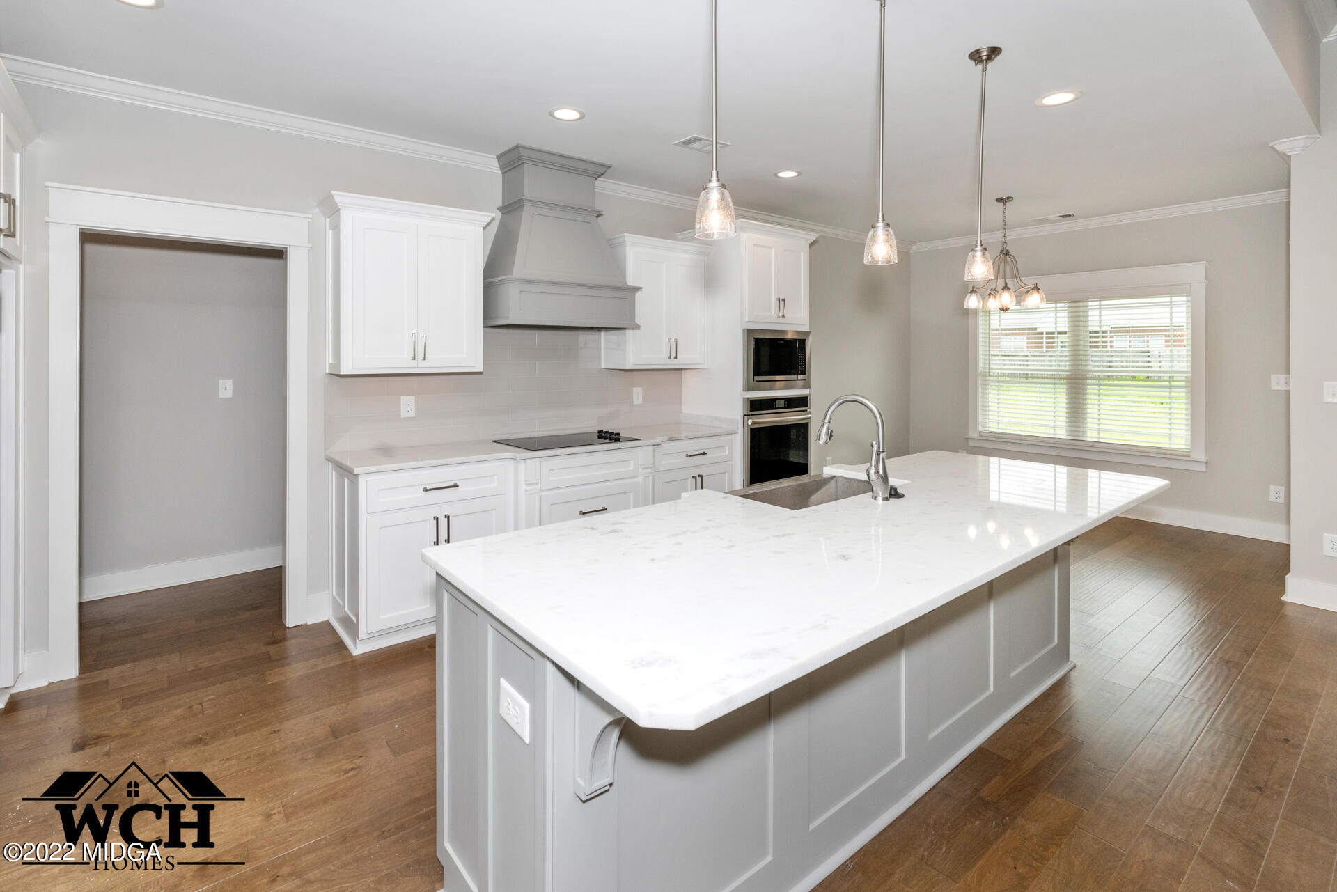 107 Perth Court Warner Robins, GA 31088 - Photo 13 of 27 a kitchen with a sink a center island a stove a refrigerator and a window