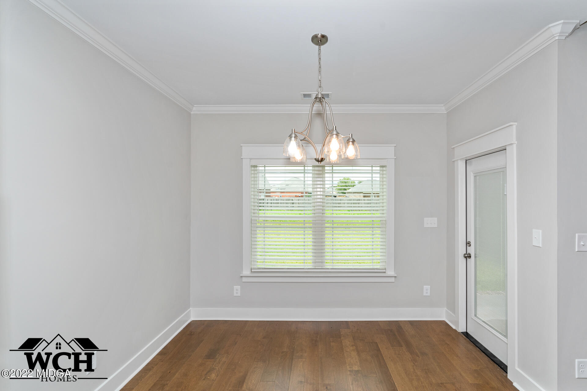 107 Perth Court Warner Robins, GA 31088 - Photo 15 of 27 a view of a room with window wooden floor and chandelier