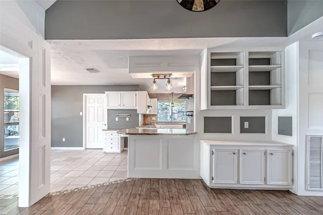 a kitchen with granite countertop white cabinets white appliances with a sink and dishwasher