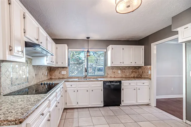a bathroom with a granite countertop shower a mirror and a sink