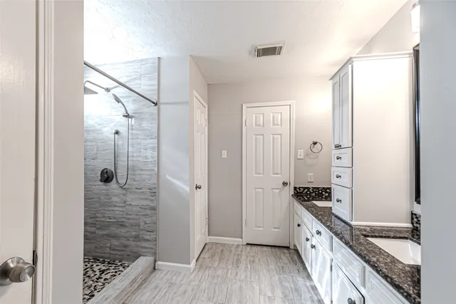 an empty room with closet and windows