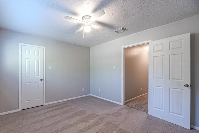 a view of a backyard with plants and brick walls