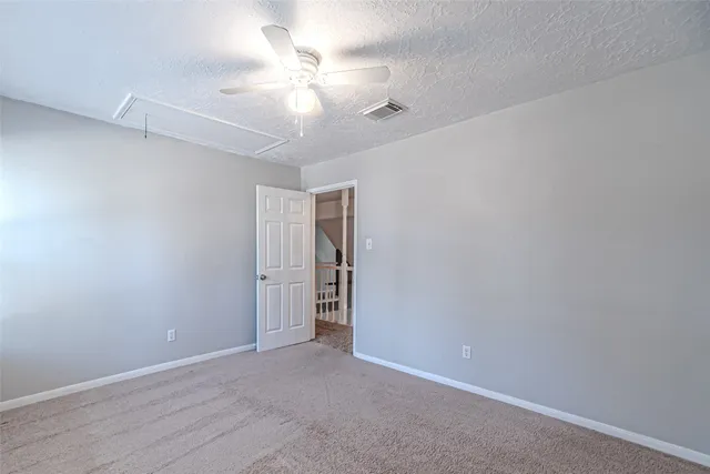 a view of a backyard with a small cabin and wooden fence