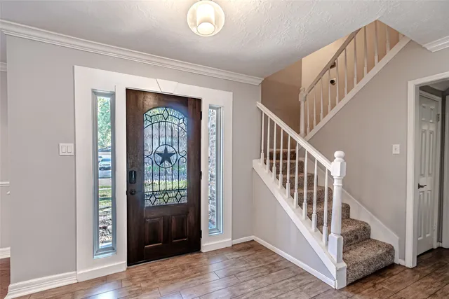 a kitchen with cabinets and wooden floor
