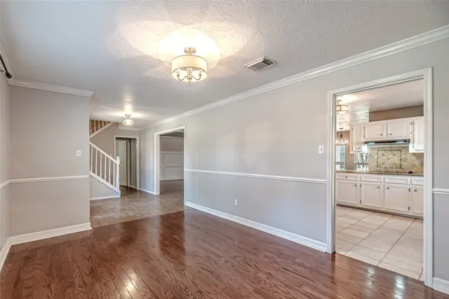 a view of an empty room with window and cabinet
