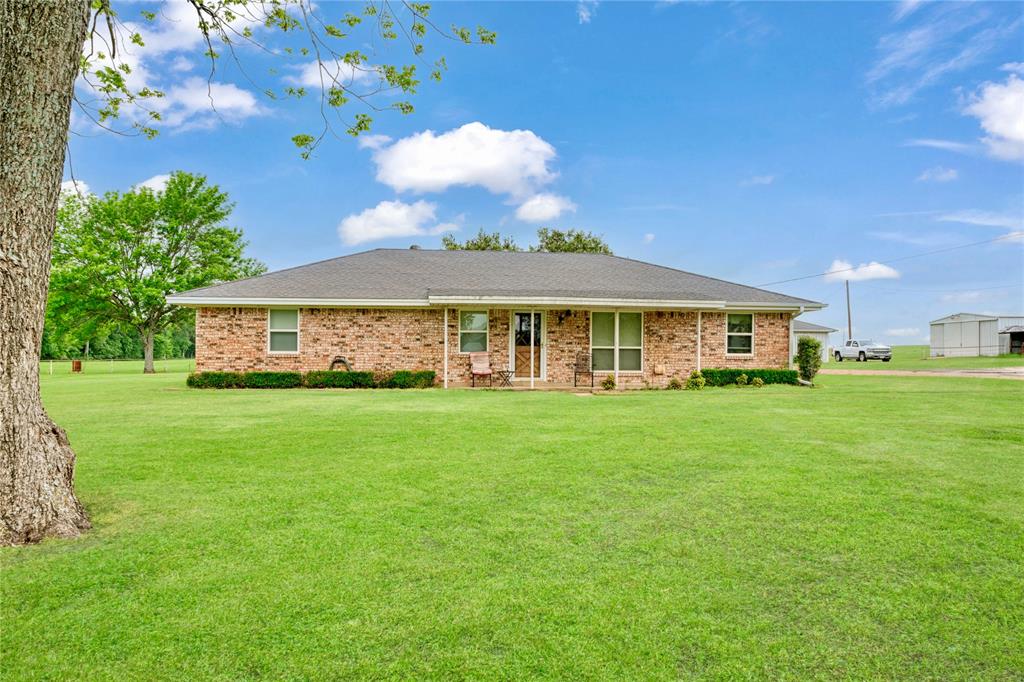 1355 County Road 33100 Sumner, TX 75486 - Photo 17 of 34 Ranch-style home with a front lawn, brick siding, and roof with shingles