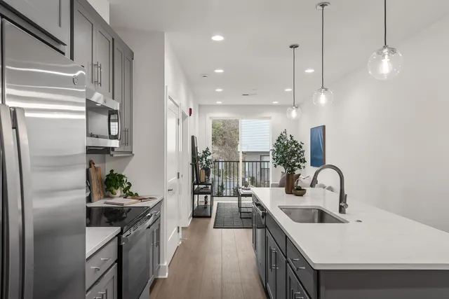 a kitchen with a sink appliances and cabinets