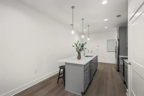 a kitchen with a refrigerator and a counter