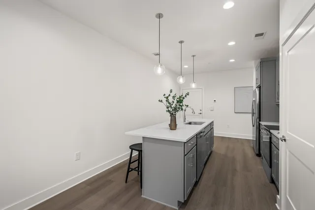 a kitchen with a refrigerator and a counter