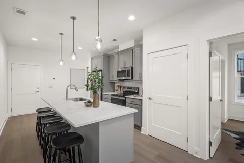 a kitchen with a refrigerator and a sink