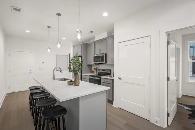 a kitchen with a refrigerator and a sink
