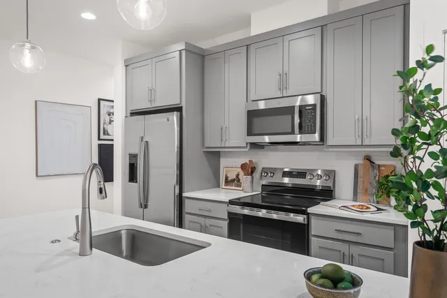 a kitchen with a sink a stove and cabinets